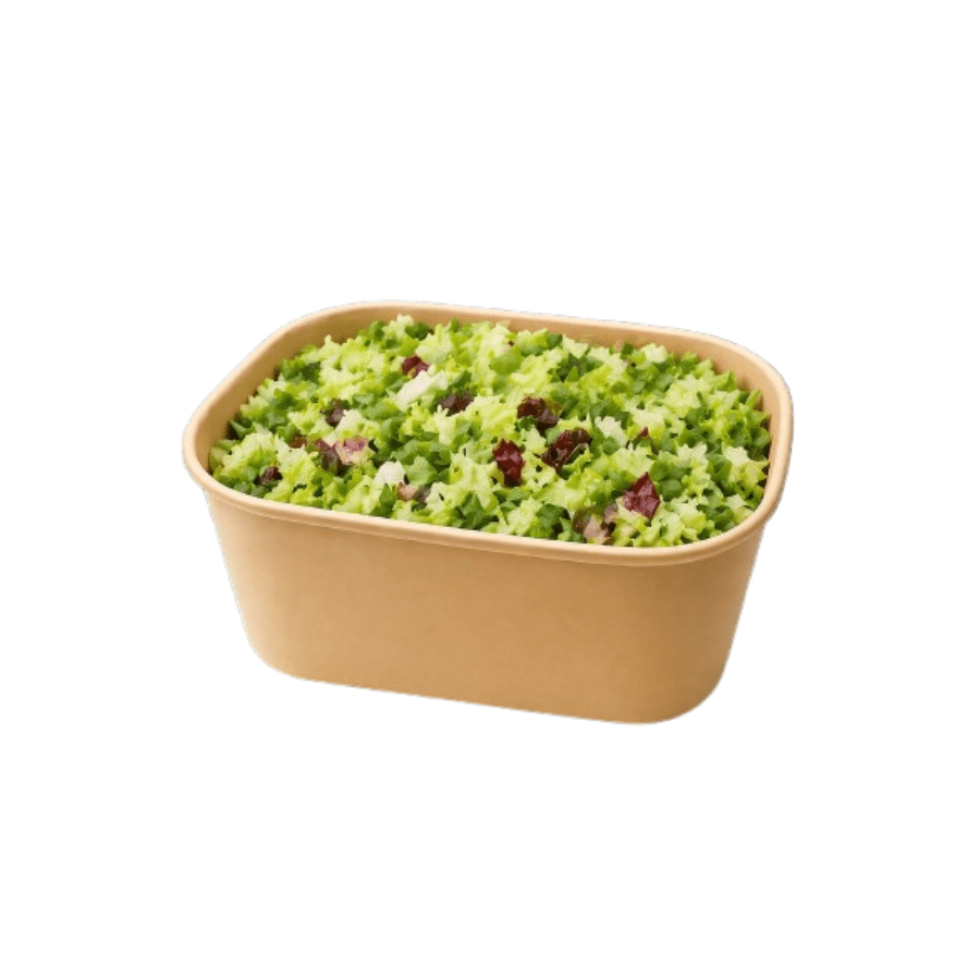 Beige rectangular baking dish filled with finely chopped green vegetables and small red pieces, resembling a herb salad or tabbouleh.
