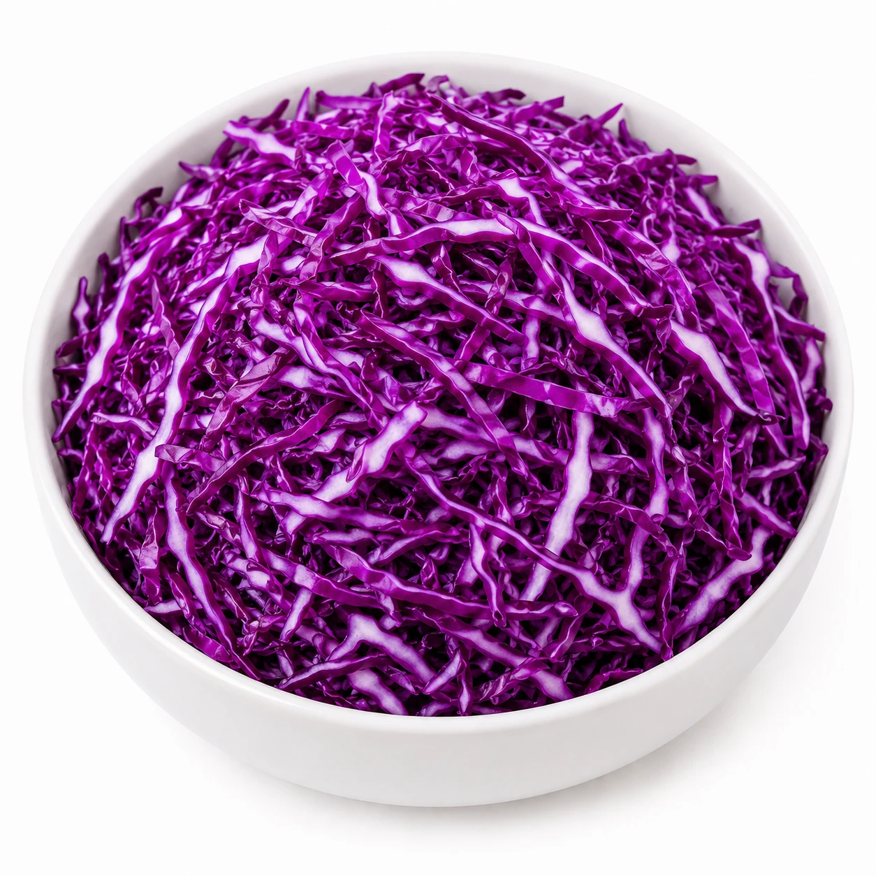 White ceramic bowl filled with freshly shredded purple cabbage